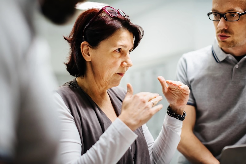 Woman explaining to small group