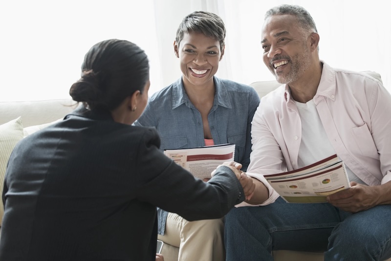 Couple shaking hands with professional