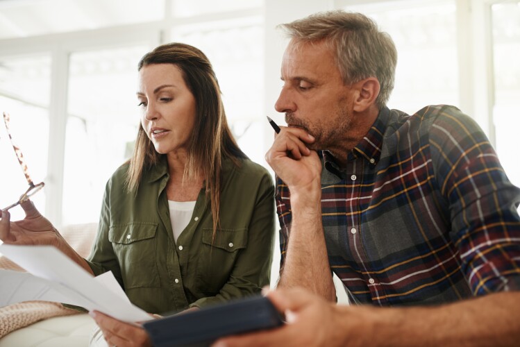 Shot of a couple managing their budget together at home