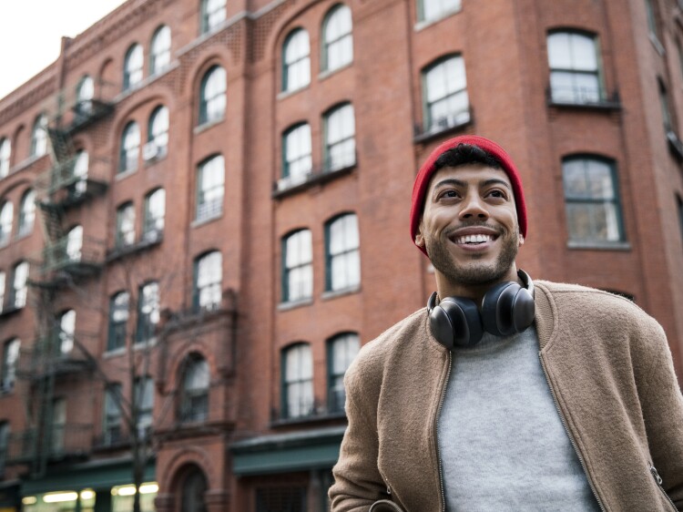 Low angle view of young man standing on city street