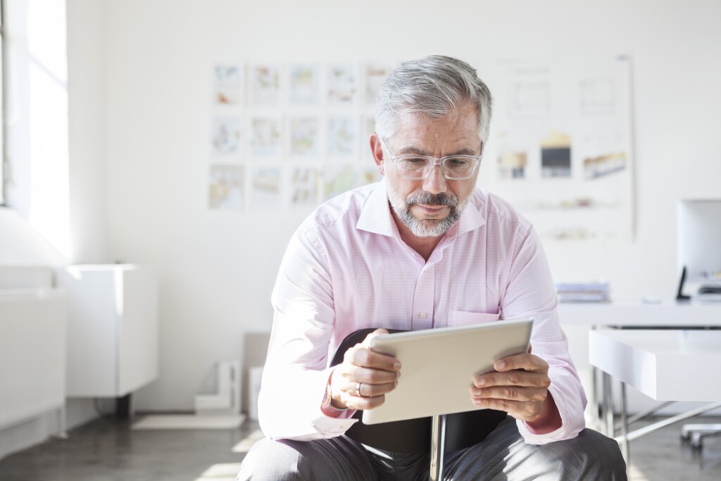 Portrait of businessman using digital tablet in an office