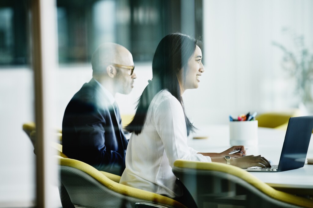 Woman working on laptop during meeting