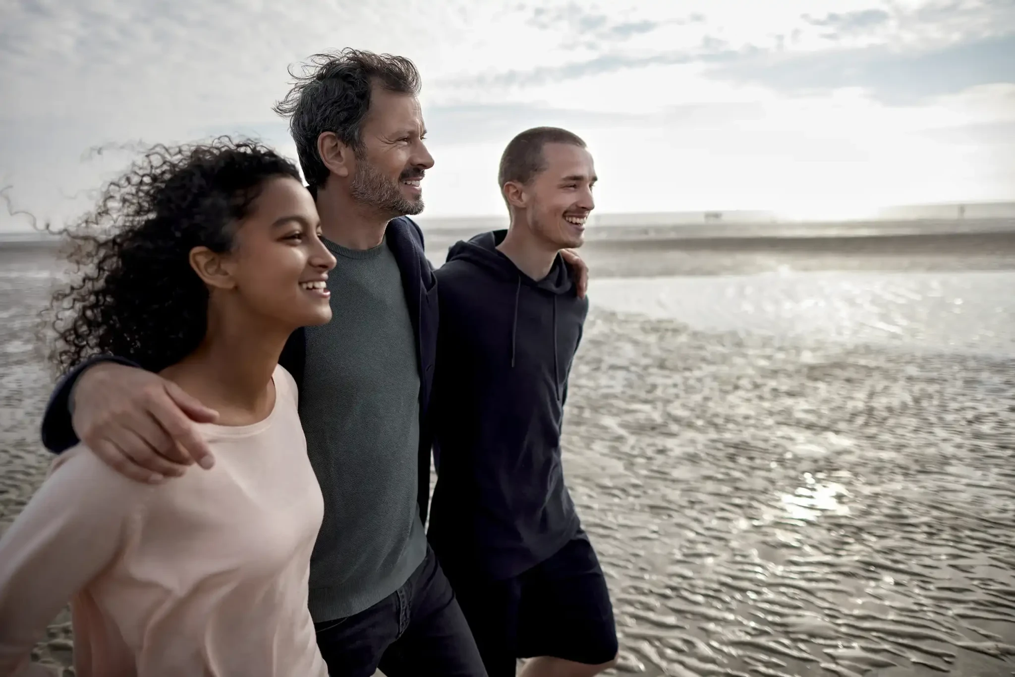 Group of three walking on the beach
