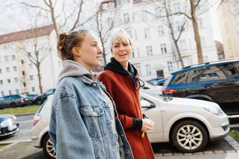 Mother and daughter walking outside