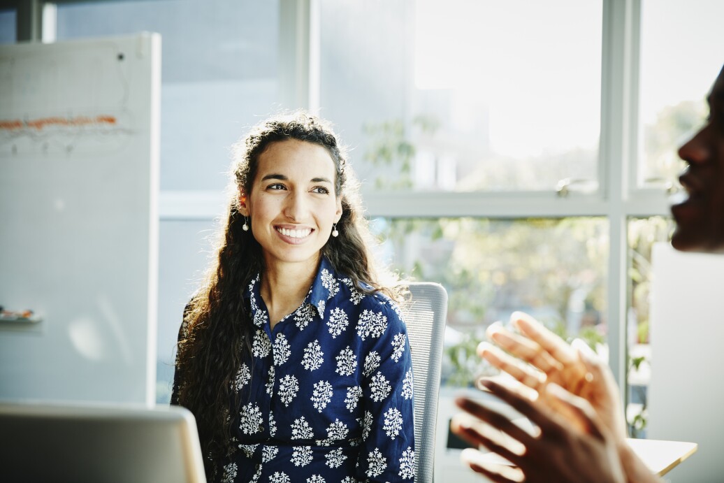 Smiling businesswoman listening to presentation
