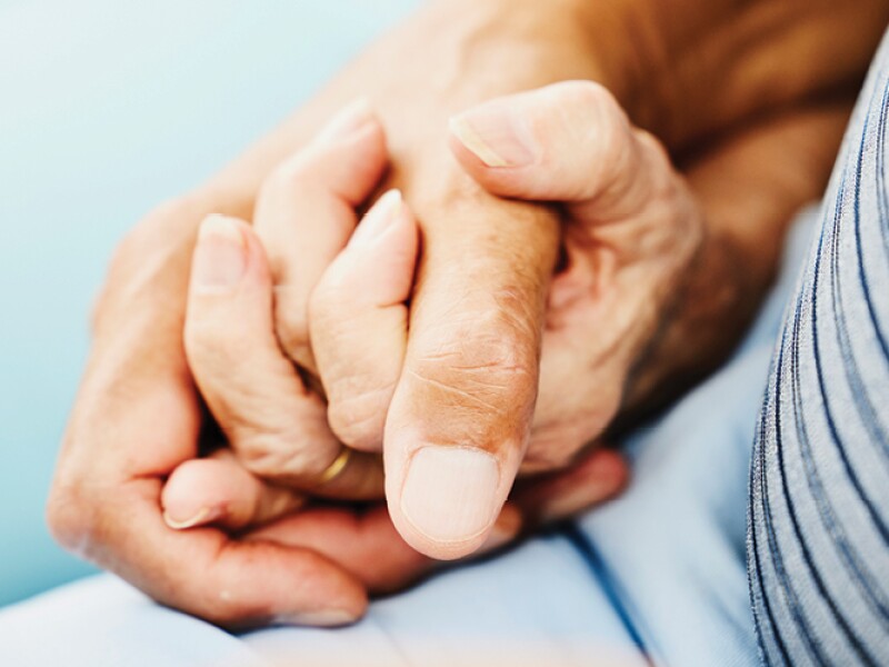 Holding hands with an aging loved one.