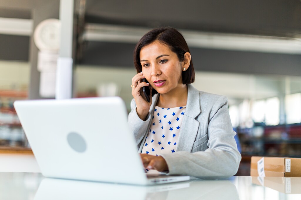 Woman on mobile and laptop