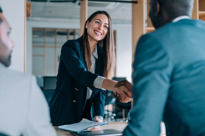 Woman shaking man's hand
