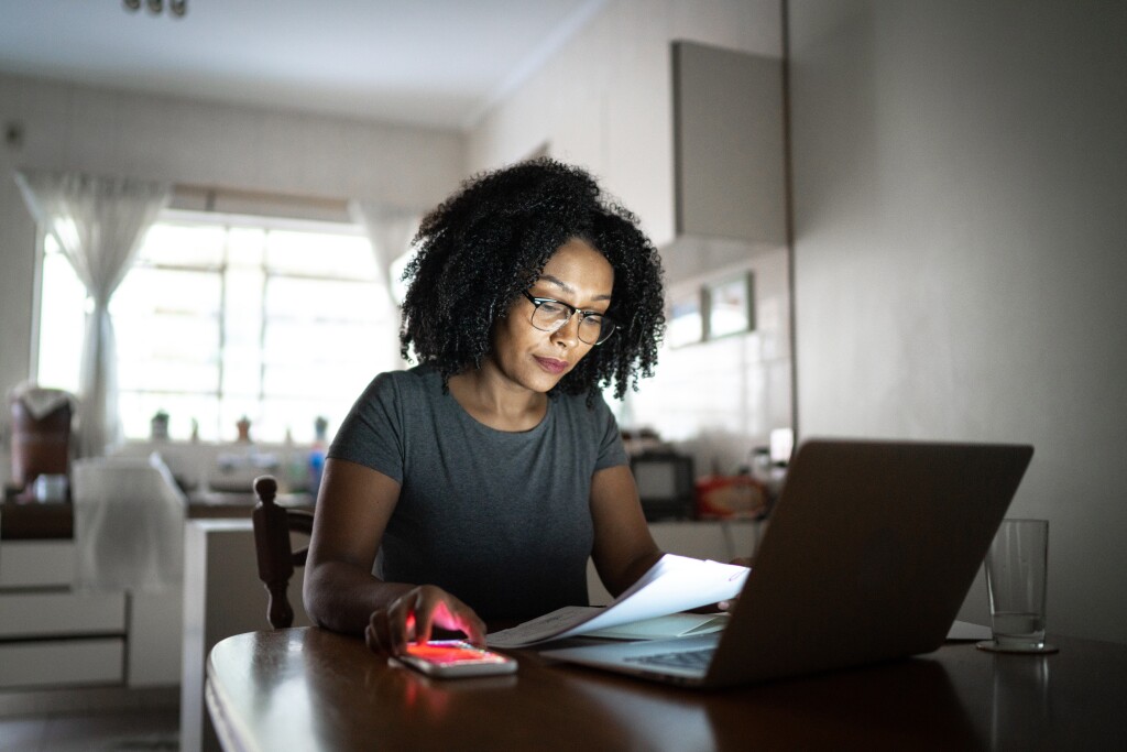 Woman looking at papers at table