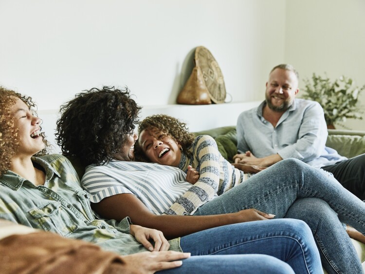 Family on couch laughing