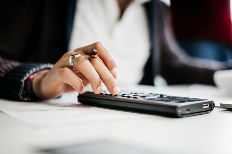Female hand using calculator