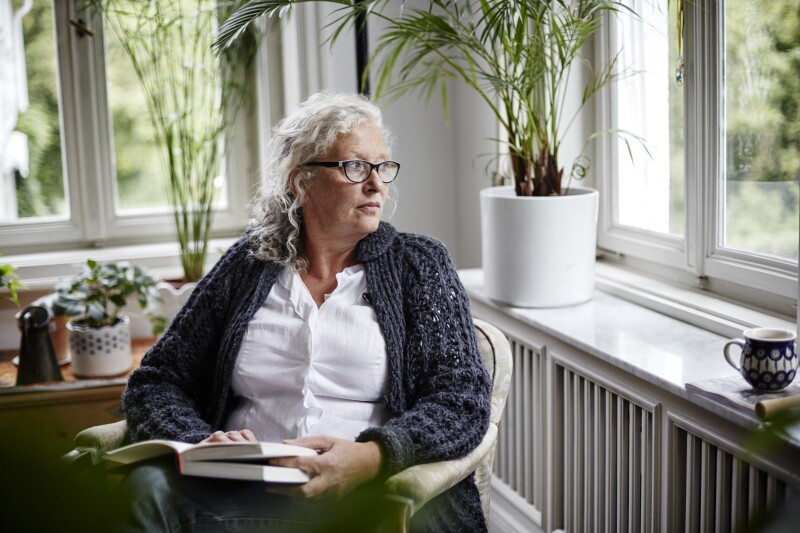 Woman reading a book at home