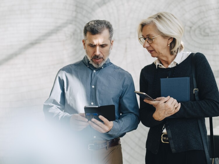4.15.32 Mature man and woman looking at their phones