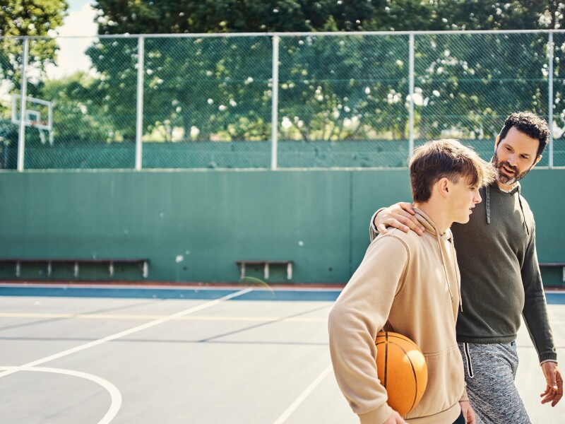 Father and son on basketball court