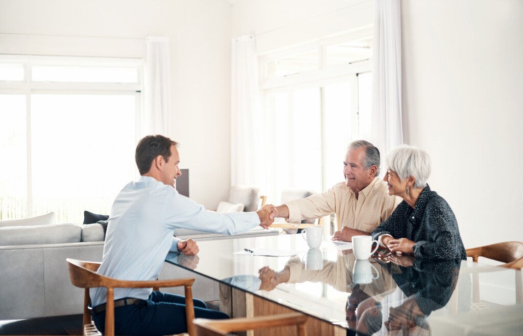 Senior couple meeting with their financial advisor at home