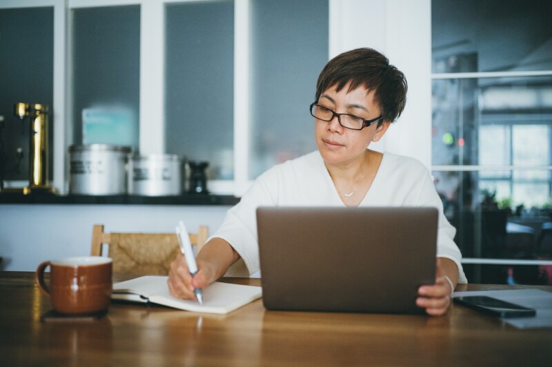 Woman working on her home finance with laptop at home