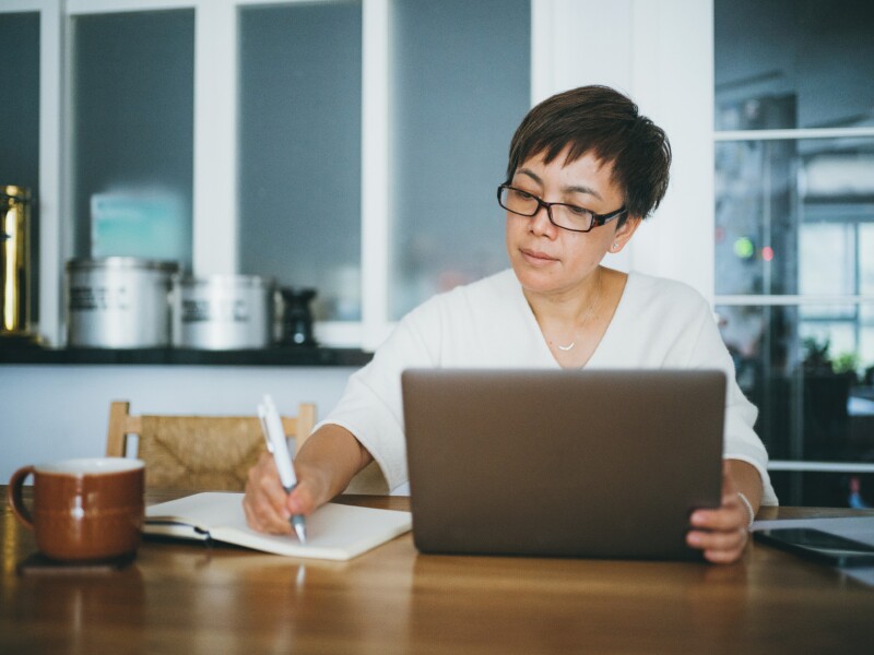 Woman working on her home finance with laptop at home
