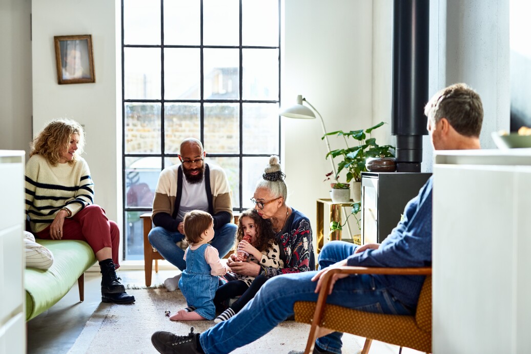 Multi generational family relaxing on weekend in living modern room