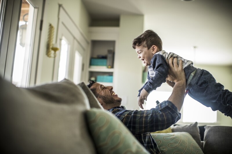 Father holding son in air