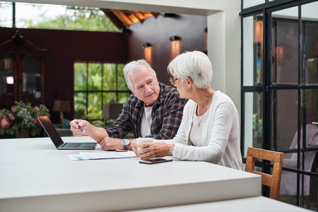 Shot of a senior couple using a laptop at home