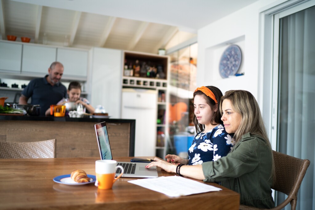 Mother working at home with daughter with special needs