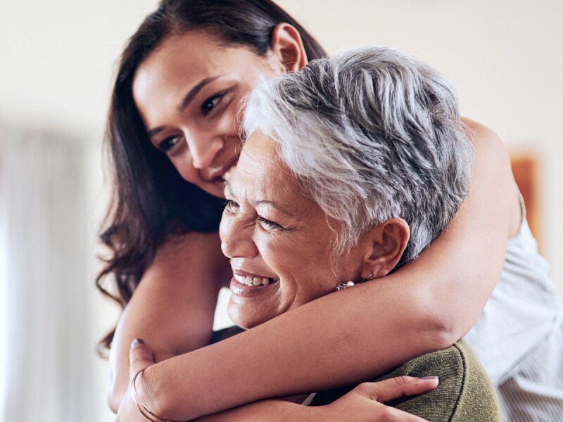 Adult daughter hugs elder mother