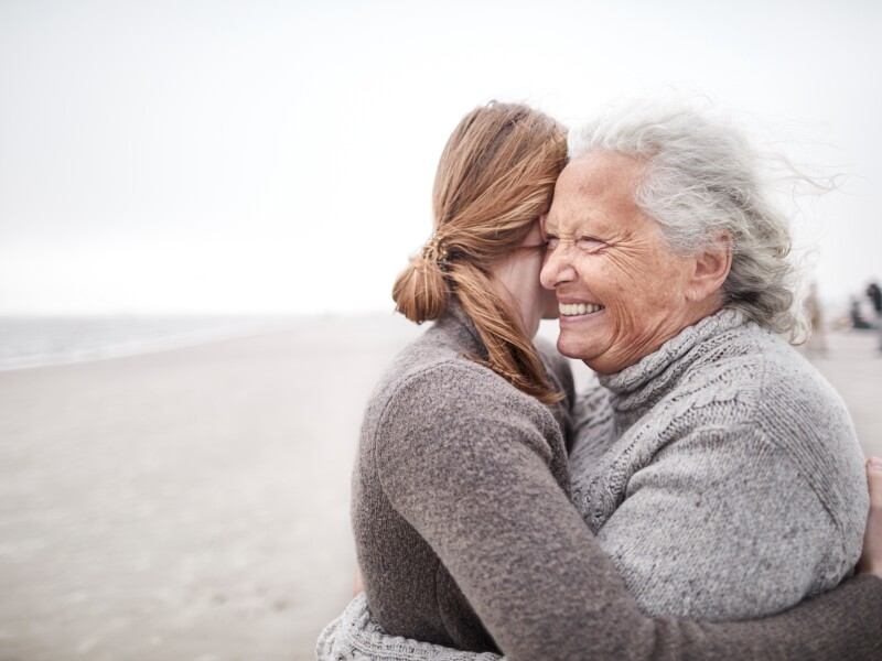 Adult daughter and mother hug