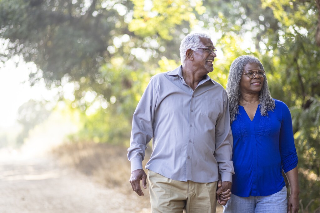 Senior black couple enjoying a nice walk on the trail.