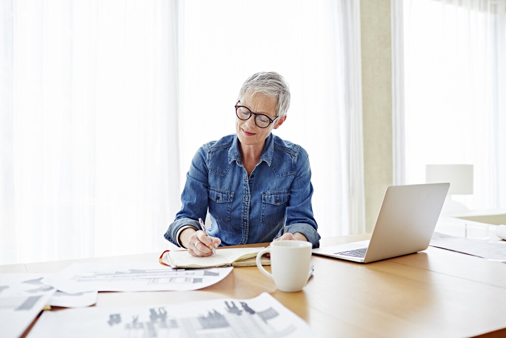 Modern mature businesswoman working at her desk