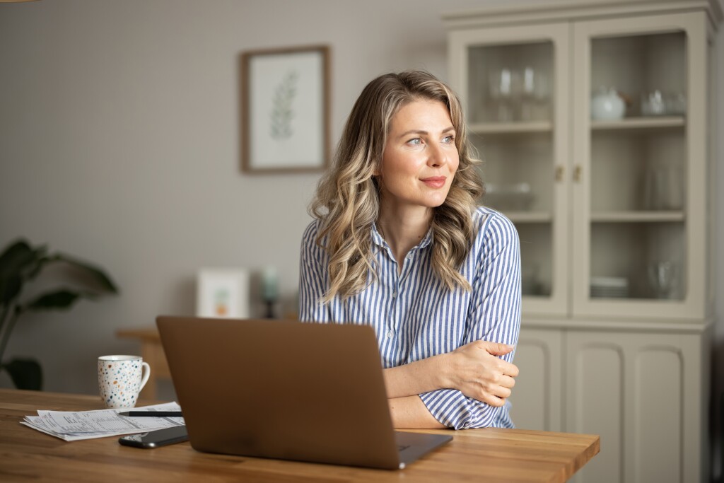 Woman managing household finances in kitchen