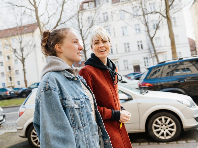 Mother and daughter walking outside