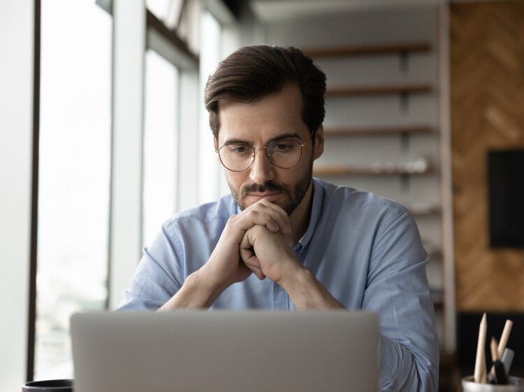 Man thinking looking at computer