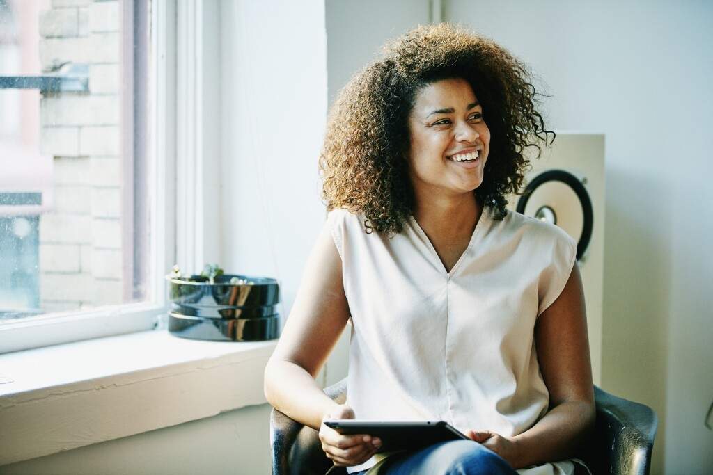 Woman smiling with tablet