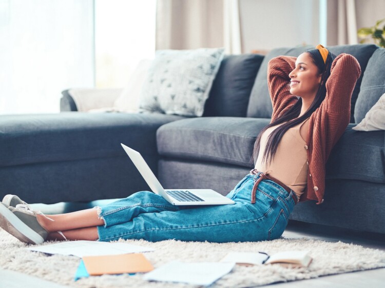 Young woman relaxing while working in the living room at home