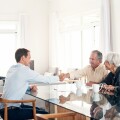 Senior couple meeting with their financial advisor at home
