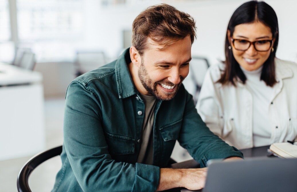 Business man using a laptop in a meeting with his colleague