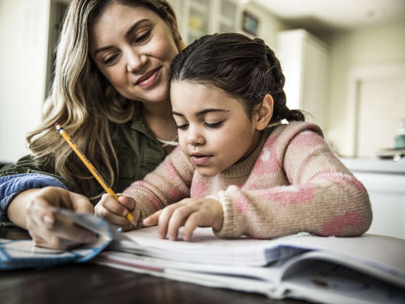Mom helping daughter with homework