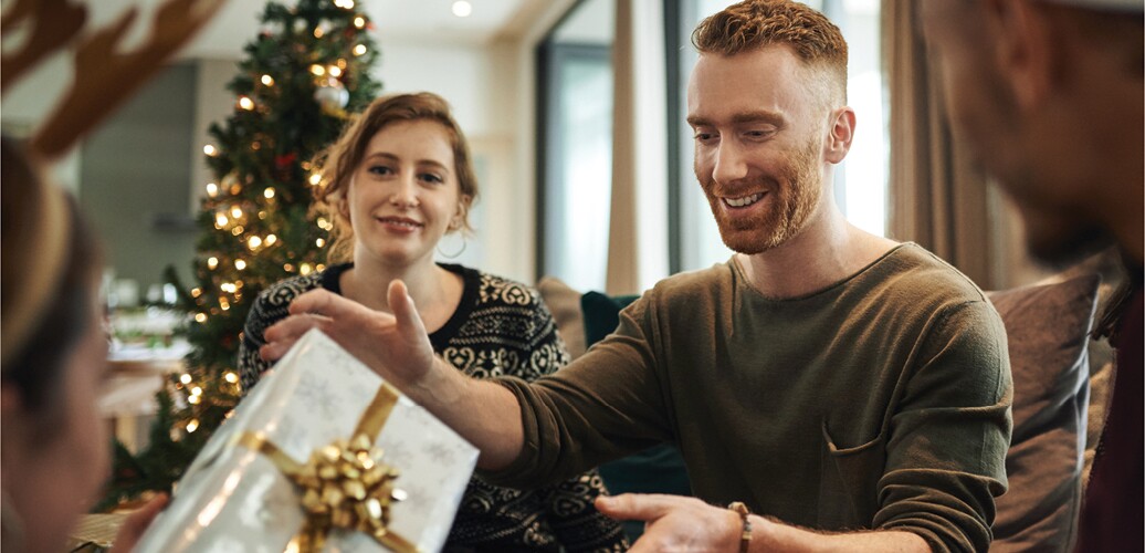 A couple shares gifts at Christmas.
