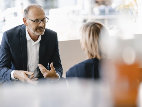 Businessman and woman having a meeting in a coffee shop