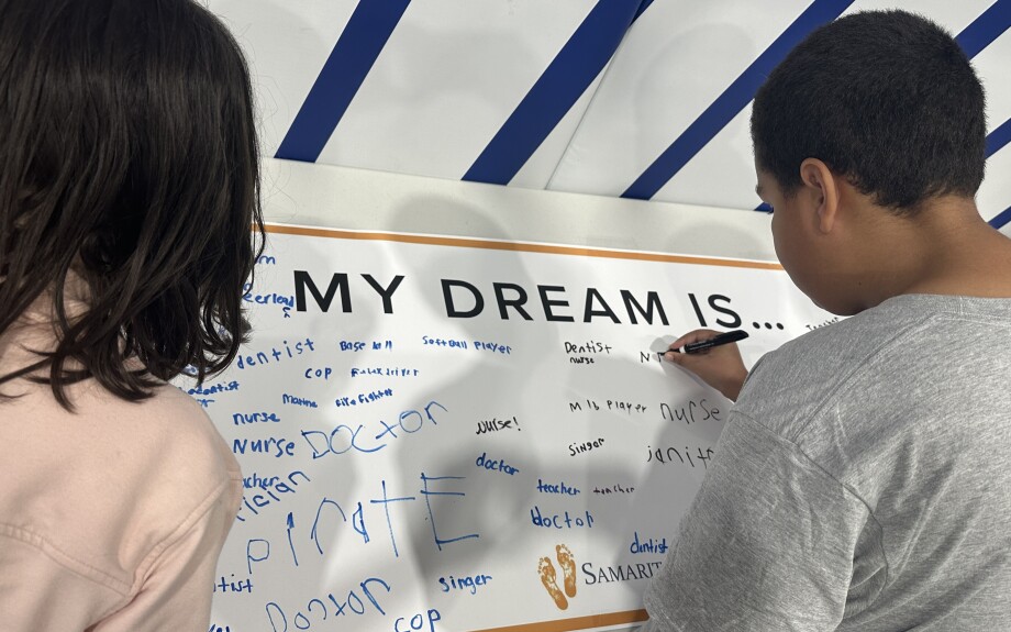 Children write their hopes and dreams on the Hope Wall.