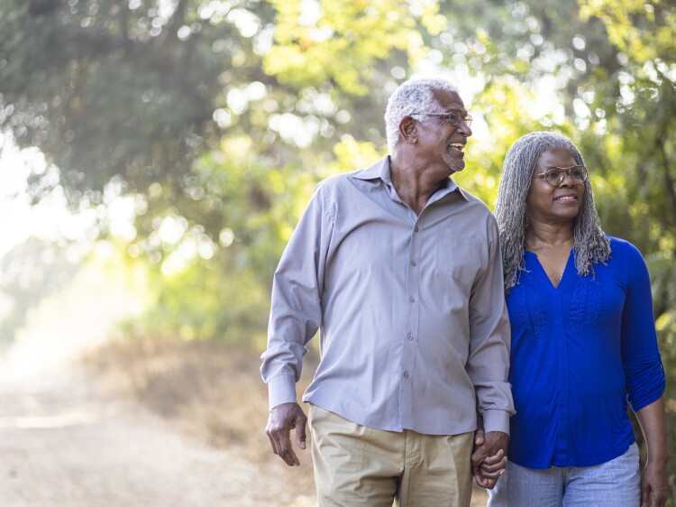 Senior black couple enjoying a nice walk on the trail.