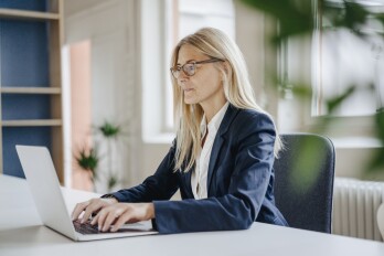 Businesswoman using laptop in office
