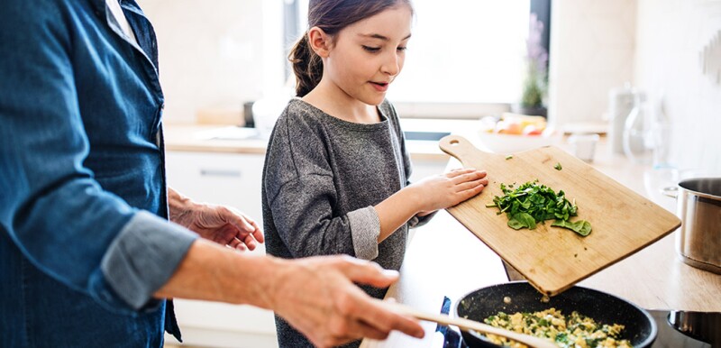 Man cooking with granddaughter