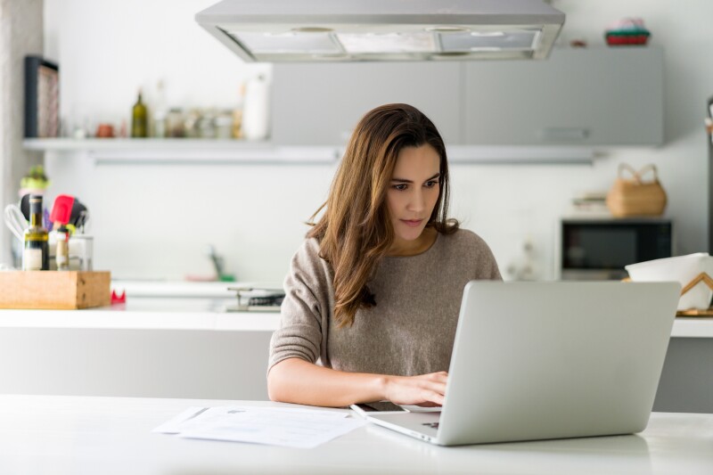 Woman working on her laptop computer at home