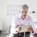Portrait of businessman using digital tablet in an office