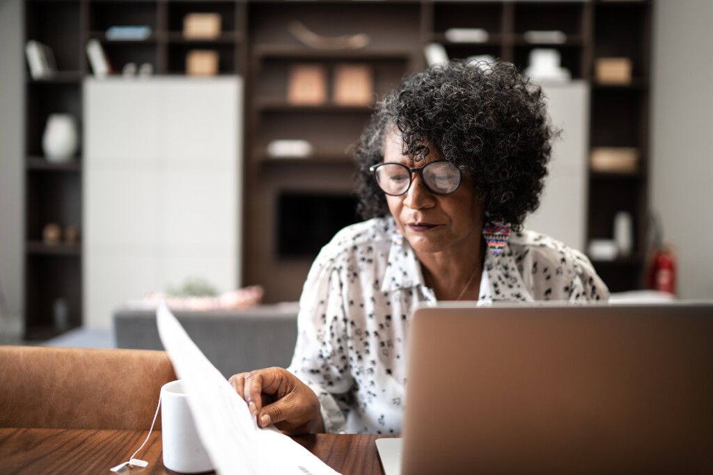 Woman working from home or using laptop planning or paying bills