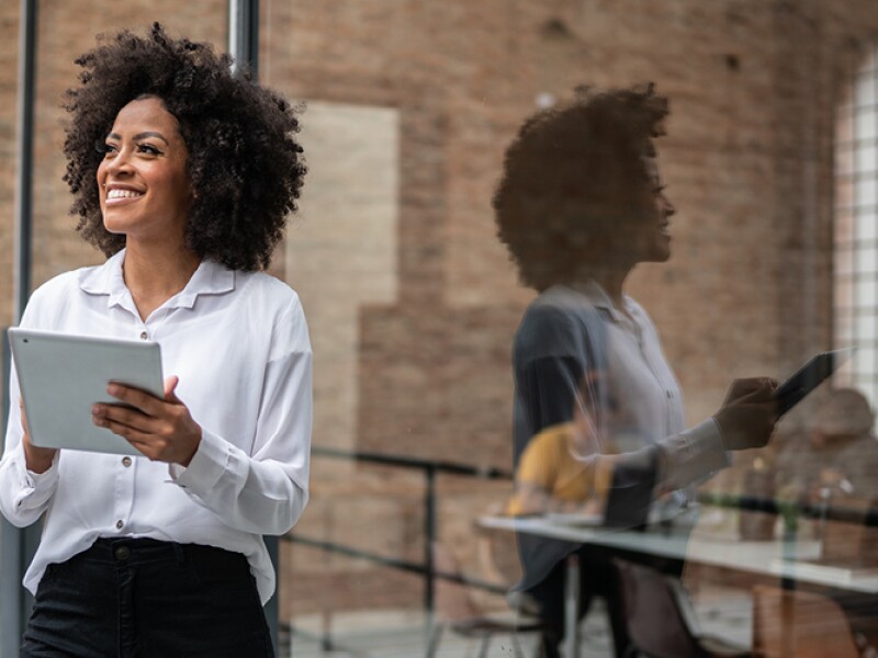 A woman is holding a tablet.