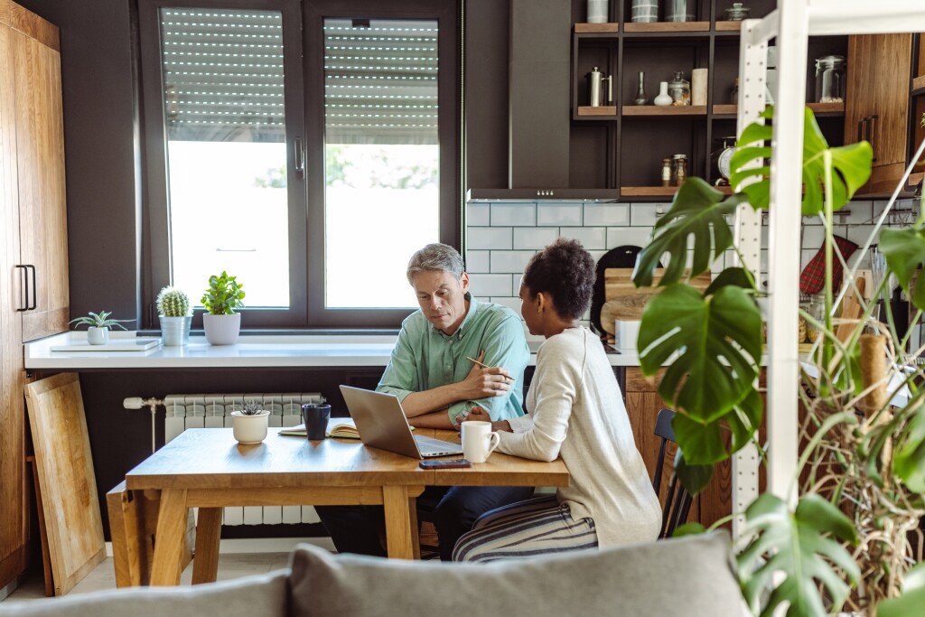 Mature couple going through finances in their kitchen