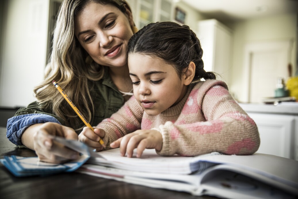 Mom helping daughter with homework