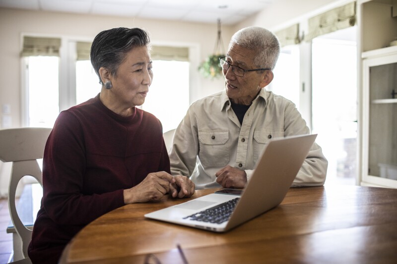 Senior couple discussing laptop contents